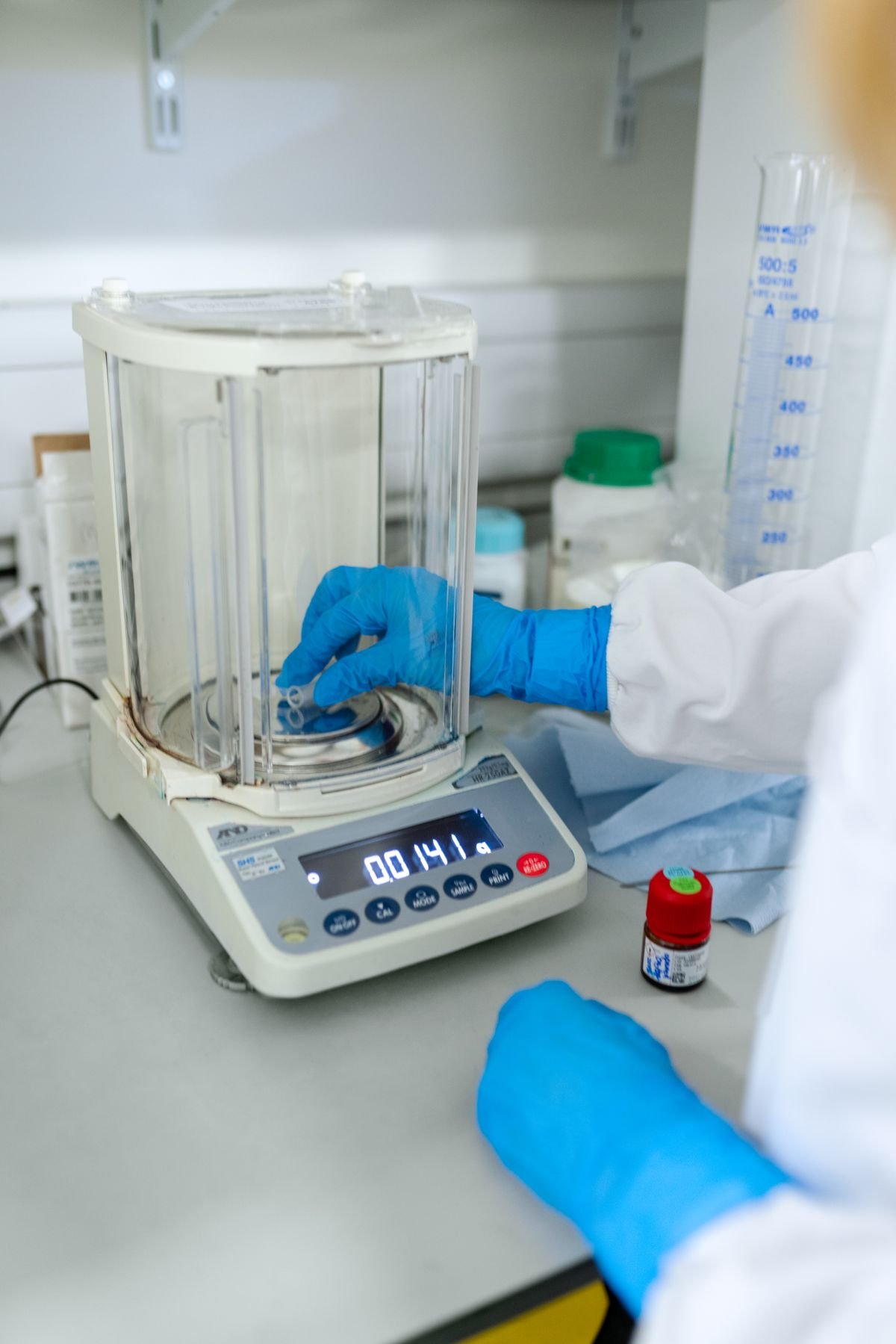 Laboratory technician performing precision calibration work